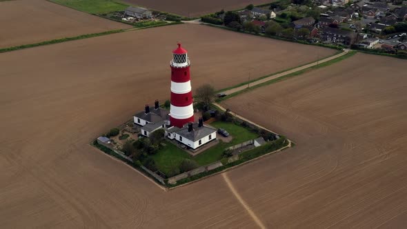 Hyperlapse of Happisburgh lighthouse rotating around it. Aerial footage from a drone.