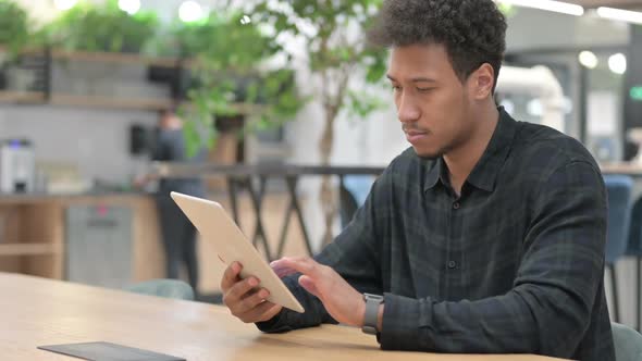 Attractive African American Man Using Tablet at Work
