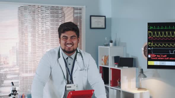 Close-up of Mixed Race Smiling Doctor in Lab Coat Walking on Treadmill