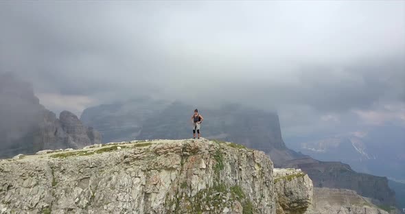 Aerial drone view of a woman hiking in the mountains