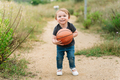 Cute little girl playing with a basketball ball - PhotoDune Item for Sale