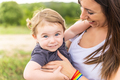 Kid in arms of a mother with a lgbt bracelet - PhotoDune Item for Sale
