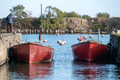 fishing boats docked in the harbor channel - PhotoDune Item for Sale