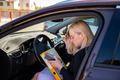 middle aged blonde business woman in glasses in car working with documents - PhotoDune Item for Sale