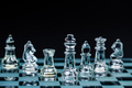 transparent glass chess pieces arranged in a row reflecting in glass chessboard. Isolated on black - PhotoDune Item for Sale
