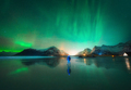 Northern Lights and man on the beach at night. Aurora borealis - PhotoDune Item for Sale