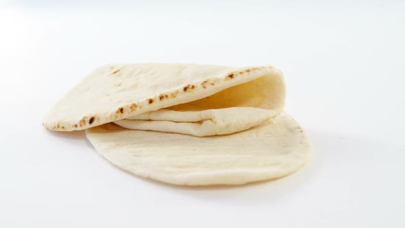 Two flat breads on white background