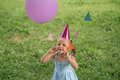 Funny humorous girl playing with festive garland of colorful flags and balloons - PhotoDune Item for Sale