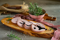 slices of Bologna PGI mortadella on wooden cutting board - PhotoDune Item for Sale