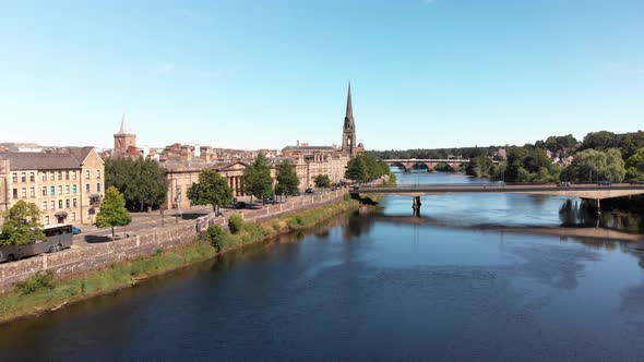 Drone view above River Tay and Perth on a sunny day with blue sky. Drone gaining altitude