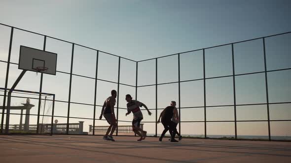 Sportive Happy People Playing Streetball on Sunlit Playground in Slowmotion