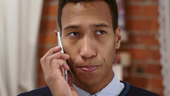 Talkative African Man Talking on Mobile PhoneNegotiation