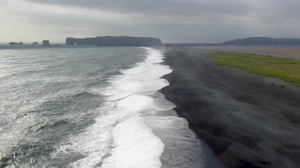 Aerial view of Dyrholaey peninsula and Reynisfjara black sand beach in Iceland