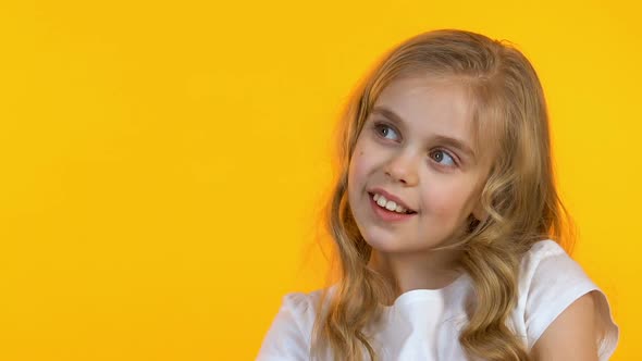 Little Girl Looking at Empty Background and Showing Thumbs-Up, Children Approval