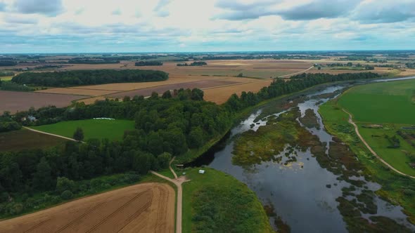 Mezotne Palace and Park With Fountain in Latvia. Lielupe River With Ponton Bridge Aerial 4K