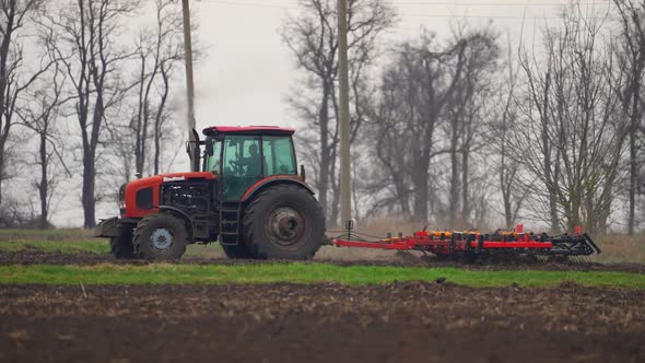 Agricultural Tractor Sowing and Cultivating Field