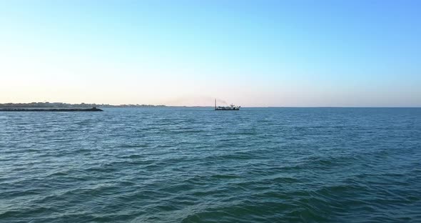 Sand Dredging Ship on the Shore of the Beach