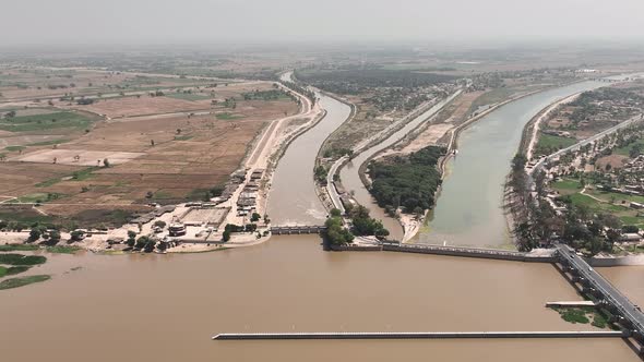 A drone shot of a countryside area where head Panjnad bridge is seen along with its surrounding