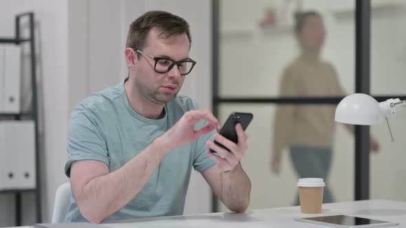 Attractive Young Man Using Smartphone Work