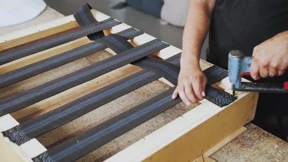 A Worker Makes a Sofa in a Furniture Factory