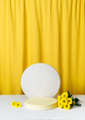 Cosmetic podium, pedestal on a bright yellow curtain background - PhotoDune Item for Sale