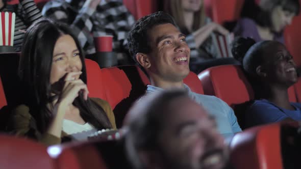 Mixed Race Couple Laughing While Watching Movie