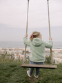 Swinging on Wooden Swing with Ocean and City View - PhotoDune Item for Sale