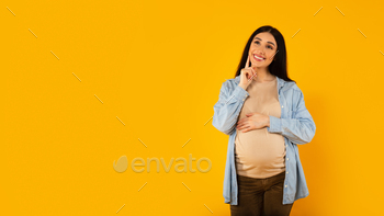y, posing on yellow background, panorama with free space. Dreaming and imagining motherhood life