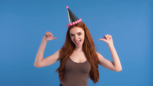 Redheaded Model in Party Hat and Brown Tank Top