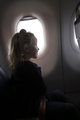 Positive girl in plane near window - PhotoDune Item for Sale