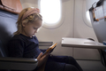 Little girl in airplane with tablet - PhotoDune Item for Sale