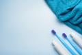 Toothbrushes with paste tube and towel on blue background. - PhotoDune Item for Sale