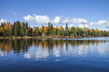 Blue trout lake with trees in autumn color in northern Minnesota on a sunny day - PhotoDune Item for Sale