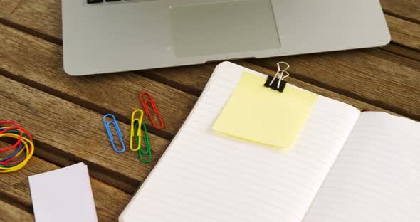 Laptop, coffee, paper clip, organizer and sticky note on table 4k