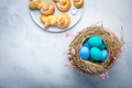 Easter eggs in nest with sweet buns made from yeast dough in a shape of Easter bunny - PhotoDune Item for Sale