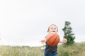 Little girl playing with a ball outdoors - PhotoDune Item for Sale