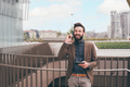 Young bearded businessman outdoors smiling talking smartphone - PhotoDune Item for Sale