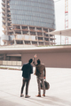 Two young contemporary businessmen back view outdoors city looking cityscape - PhotoDune Item for Sale
