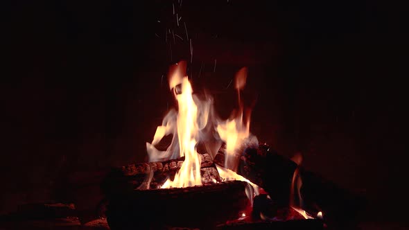 Fireplace with burning wood at night