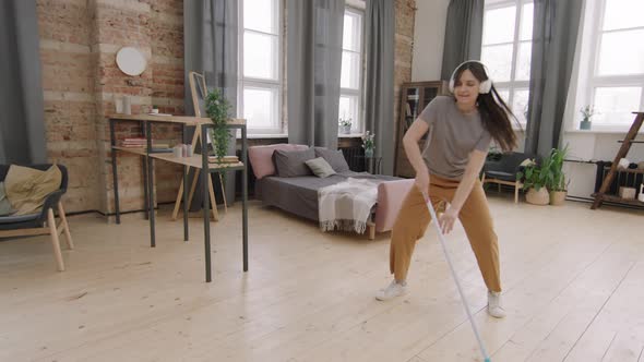 Slowmo of Woman Dancing and Mopping Floor