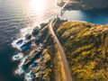 Aerial view of bridge, car, sea with waves and rocks at sunset - PhotoDune Item for Sale