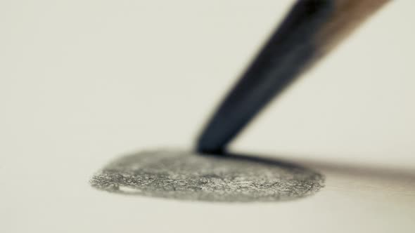 Graphite Pencil Draws a Dot Circle Line on a White Background Paper, Macro Shot alt