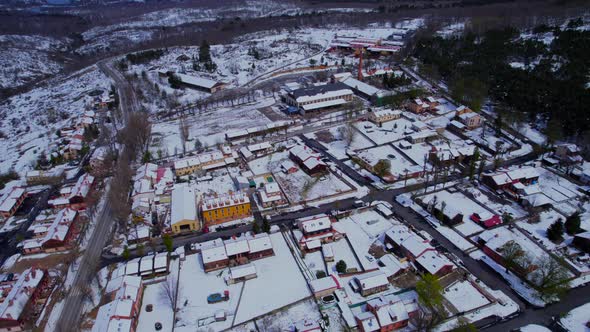 High angle aerial pull-out over Pradera de Navalhorno covered in snow in the heart of the Spanish wi