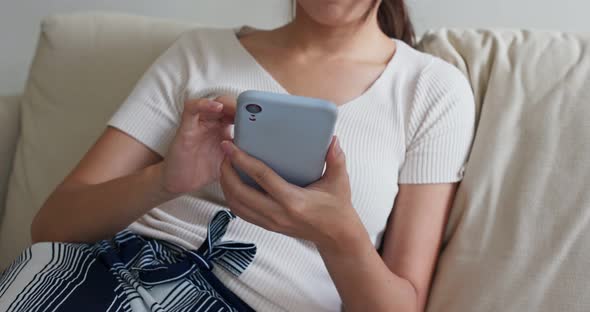 Woman use of cellphone at home