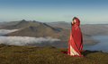 A  woman in old-fashioned clothes with a bright red cloak. Faroe Islands, Denmark - PhotoDune Item for Sale