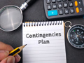 Hamd holding pencil wriiten on notebook with the word Contingencies Plan. Business concept. - PhotoDune Item for Sale
