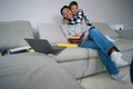 Boy hugs his mother, who is studying online courses at home - PhotoDune Item for Sale