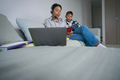 Boy watches his mother take online courses at home - PhotoDune Item for Sale