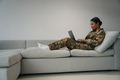 Young soldier woman is typing something in a laptop - PhotoDune Item for Sale