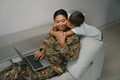 Military woman is located with a laptop on the sofa - PhotoDune Item for Sale